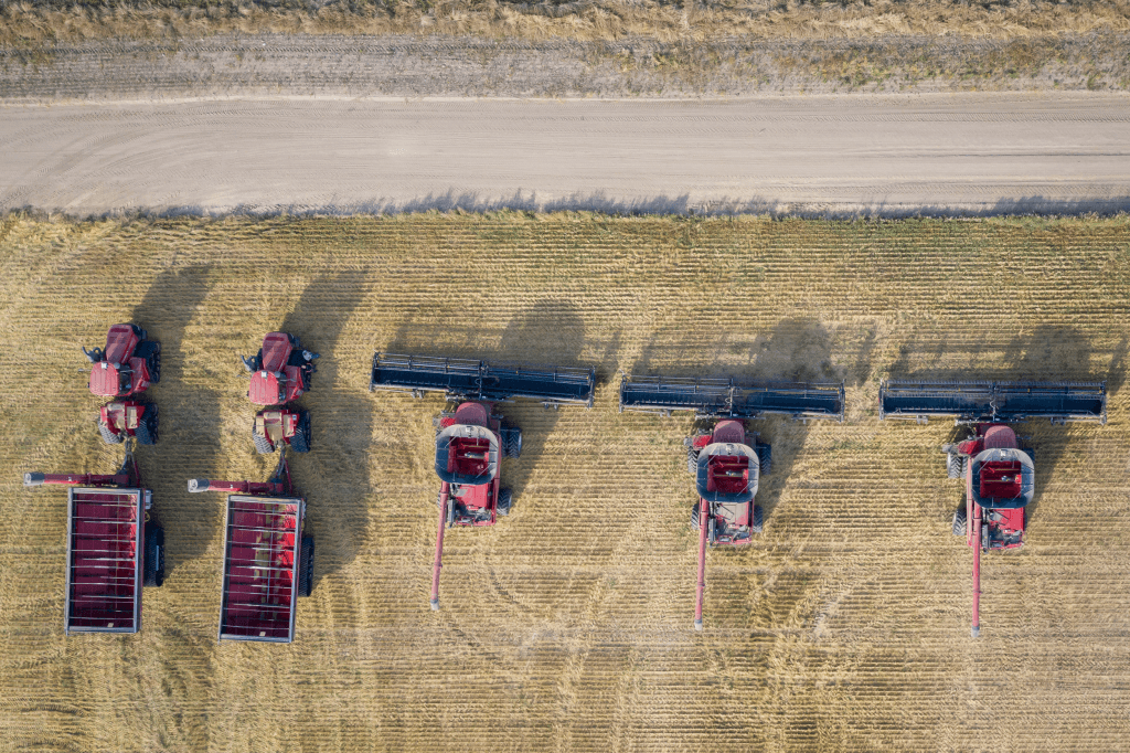 aerial-overhead-shot-combine-harvesters-farming-field-daytime
