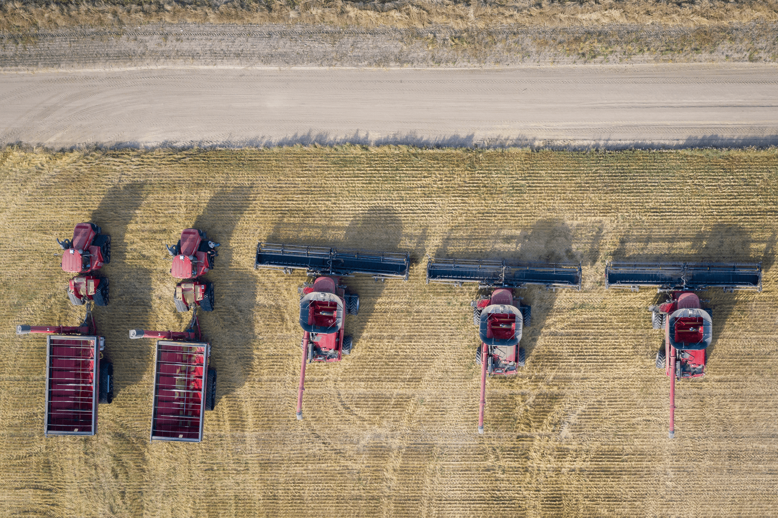 aerial-overhead-shot-combine-harvesters-farming-field-daytime